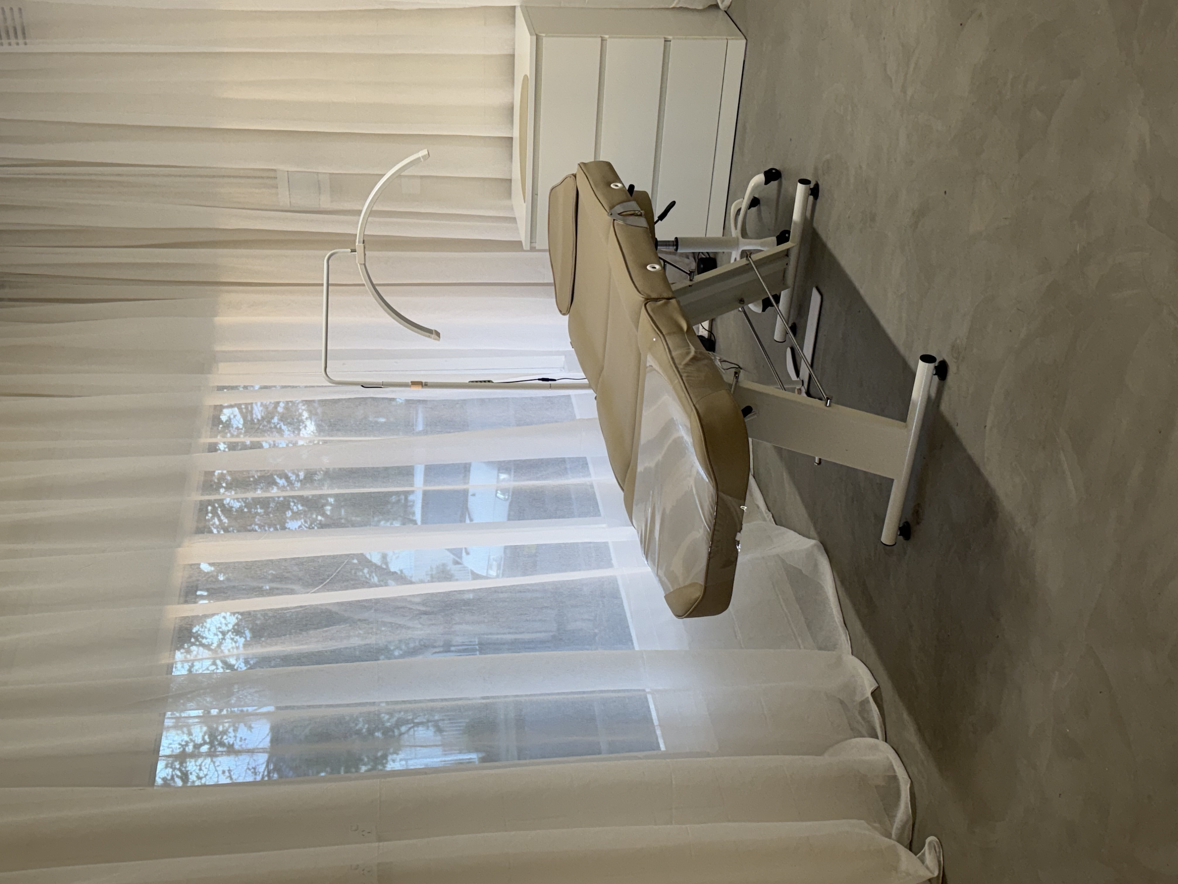 The treatment bed at Bhava Beauty, backlit by sheer curtains